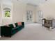 Bright room with hardwood floors, a comfortable green velvet couch, and French doors at 4300 Old Course Dr, Charlotte, NC 28277