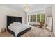 Bright main bedroom with a large window, modern lighting and wood flooring at 4300 Old Course Dr, Charlotte, NC 28277