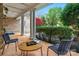 Inviting outdoor patio with tiled floor, classic columns, comfortable seating, and garden views at 4300 Old Course Dr, Charlotte, NC 28277