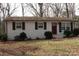 Charming brick home with a front porch, small shrubs, and natural light through large windows at 508 S Jackson Ave, Waxhaw, NC 28173