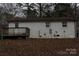 White-painted home featuring a back deck and small backyard space covered with dried leaves at 508 S Jackson Ave, Waxhaw, NC 28173