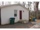 Rear exterior view of a home with a brick facade, small deck area, and private backyard at 508 S Jackson Ave, Waxhaw, NC 28173