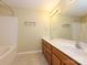 Well-lit bathroom features double vanity, framed mirror, and tub with shower at 535 Donatello Ave, Charlotte, NC 28205