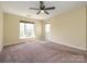 Large bedroom with a window providing natural light and a ceiling fan for comfort at 535 Donatello Ave, Charlotte, NC 28205