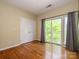 Bright bedroom featuring hardwood floors, large windows and a sliding glass door to a balcony at 535 Donatello Ave, Charlotte, NC 28205