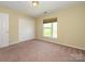 Bedroom offering plush carpet, a window, and double door closet at 535 Donatello Ave, Charlotte, NC 28205