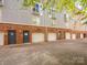 Exterior view showing garages and entrances at the building's rear at 535 Donatello Ave, Charlotte, NC 28205
