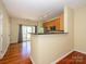 Modern kitchen with hardwood floors, granite countertops, breakfast bar, and stainless steel appliances at 535 Donatello Ave, Charlotte, NC 28205