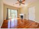 A bright living room featuring hardwood floors, ceiling fan, and sliding glass door to balcony at 535 Donatello Ave, Charlotte, NC 28205
