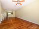 Open-concept living room with hardwood floors, light fixtures, and neutral wall paint at 535 Donatello Ave, Charlotte, NC 28205