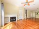 A bright living room featuring hardwood floors, a fireplace, and open floor plan at 535 Donatello Ave, Charlotte, NC 28205