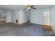 Spacious living room showing access to the kitchen and additional bedrooms and neutral carpet at 6005 Fringe Tree Dr, Charlotte, NC 28227
