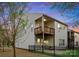 Exterior view of the home with a spacious backyard, deck, and black fence at 6020 Union Pacific Ave, Charlotte, NC 28210