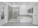 Well-lit bathroom features a separate shower, soaking tub, and elegant tile finishes at 6020 Union Pacific Ave, Charlotte, NC 28210