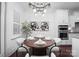 Well-lit dining area with table setting, modern chandelier, and easy access to the kitchen and living areas at 6020 Union Pacific Ave, Charlotte, NC 28210