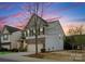 Two-story home showcasing stone and siding, with a two-car garage and manicured landscaping at 6020 Union Pacific Ave, Charlotte, NC 28210