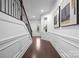 Bright hallway featuring hardwood floors, wainscoting detail, and decorative artwork on the walls at 6020 Union Pacific Ave, Charlotte, NC 28210