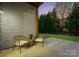 Outdoor patio seating area with wicker chairs, offering a relaxing view of the landscaped backyard at 6020 Union Pacific Ave, Charlotte, NC 28210