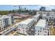 Cityscape aerial view showcasing a mix of townhomes and apartments with ongoing urban construction, surrounded by lush greenery at 631 W Tremont Ave, Charlotte, NC 28203
