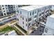 Aerial view of modern townhomes featuring balconies, a parking area, and contemporary design at 631 W Tremont Ave, Charlotte, NC 28203