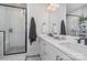 Modern bathroom with dual sinks, quartz countertops, and walk-in shower with black trim at 631 W Tremont Ave, Charlotte, NC 28203
