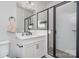 Modern bathroom with white vanity, quartz countertops, and a glass shower with black trim at 631 W Tremont Ave, Charlotte, NC 28203