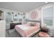 Sunlit bedroom features stylish mandala wall art, house plants, and lots of natural light at 631 W Tremont Ave, Charlotte, NC 28203