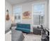 Cozy bedroom featuring two windows, a futon, and a decorative guitar on the wall at 631 W Tremont Ave, Charlotte, NC 28203