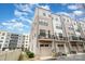 Contemporary townhome showcasing an exterior elevation, featuring a balcony, garage and modern architectural details at 631 W Tremont Ave, Charlotte, NC 28203