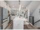 Modern kitchen featuring an island with bar seating and an open view of the staircase at 631 W Tremont Ave, Charlotte, NC 28203