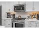 Modern kitchen with stainless steel appliances, granite countertops, and ample cabinet space for storage at 631 W Tremont Ave, Charlotte, NC 28203