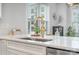 The open-concept kitchen has a large island and a stylish golden faucet and decor at 631 W Tremont Ave, Charlotte, NC 28203
