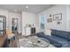 Living room showcases a wet bar, blue sectional, and a stylish coffee table on a plush rug at 631 W Tremont Ave, Charlotte, NC 28203