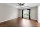 Spacious bedroom featuring wood floors and a large window at 6619 Portland Rose Ln, Charlotte, NC 28210