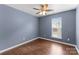 Bedroom with wood floors, blue walls, and a window at 6619 Portland Rose Ln, Charlotte, NC 28210