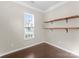 Spare bedroom featuring wood floors, a window, and shelving at 6619 Portland Rose Ln, Charlotte, NC 28210