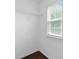 A bright walk-in closet featuring white walls, wood floors and a window at 6619 Portland Rose Ln, Charlotte, NC 28210