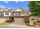 Inviting townhome boasts a stone and siding facade, garage, and lush landscaping at 6619 Portland Rose Ln, Charlotte, NC 28210