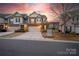 Beautiful townhome with a stone facade, attached garage, and well-maintained driveway at 6619 Portland Rose Ln, Charlotte, NC 28210