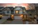Attractive townhome boasts a well-kept lawn and attached garage at 6619 Portland Rose Ln, Charlotte, NC 28210