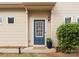 Cozy home entrance with a blue front door, classic siding, and manicured bushes at 6619 Portland Rose Ln, Charlotte, NC 28210