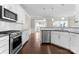 Modern kitchen with stainless steel appliances, dark laminate flooring, and granite countertops at 6619 Portland Rose Ln, Charlotte, NC 28210