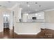 Modern kitchen featuring sleek white cabinetry, granite counters, stainless appliances, and pendant lighting at 6619 Portland Rose Ln, Charlotte, NC 28210