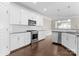 Bright kitchen with stainless steel appliances, white cabinets, and granite countertops at 6619 Portland Rose Ln, Charlotte, NC 28210