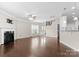 A well-lit living room showcasing dark laminate flooring, fireplace, and open layout at 6619 Portland Rose Ln, Charlotte, NC 28210