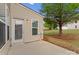 A backyard patio featuring access door, natural gas meter, and tree at 6619 Portland Rose Ln, Charlotte, NC 28210