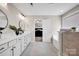 Open bathroom with tub, shower, double vanities and an open door to main bedroom at 704 Fresia Dr, Tega Cay, SC 29708