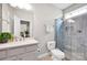 Modern bathroom featuring tiled shower, toilet and vanity with sink at 704 Fresia Dr, Tega Cay, SC 29708