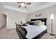 Comfortable bedroom with decorative pillows, tray ceiling, and modern ceiling fan at 704 Fresia Dr, Tega Cay, SC 29708