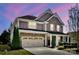 Charming two-story home featuring a stone facade, two-car garage, and well-manicured landscaping at 704 Fresia Dr, Tega Cay, SC 29708